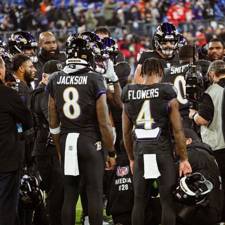 the baltimore football team huddle together on the sidelines before their game against the new york giants