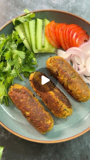 an image of a plate with food on it that includes vegetables and meat patties