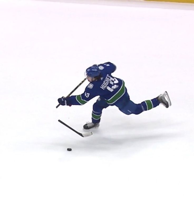 a person on skis in the snow with poles and helmet, skating down an ice rink