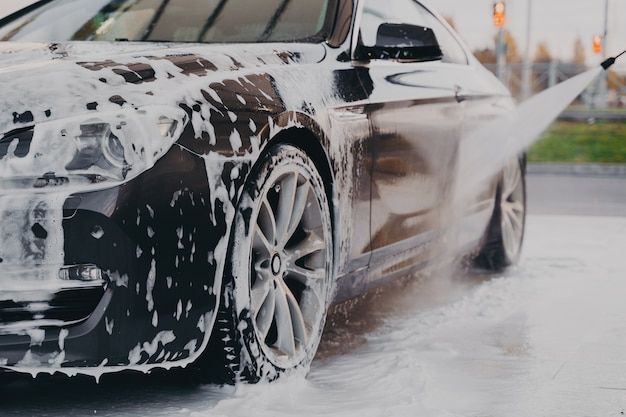 a car is washing it's wheels with water