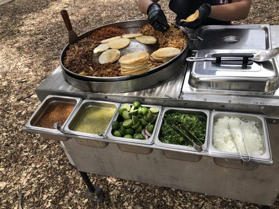 the food is prepared and ready to be eaten at the buffet table in the park