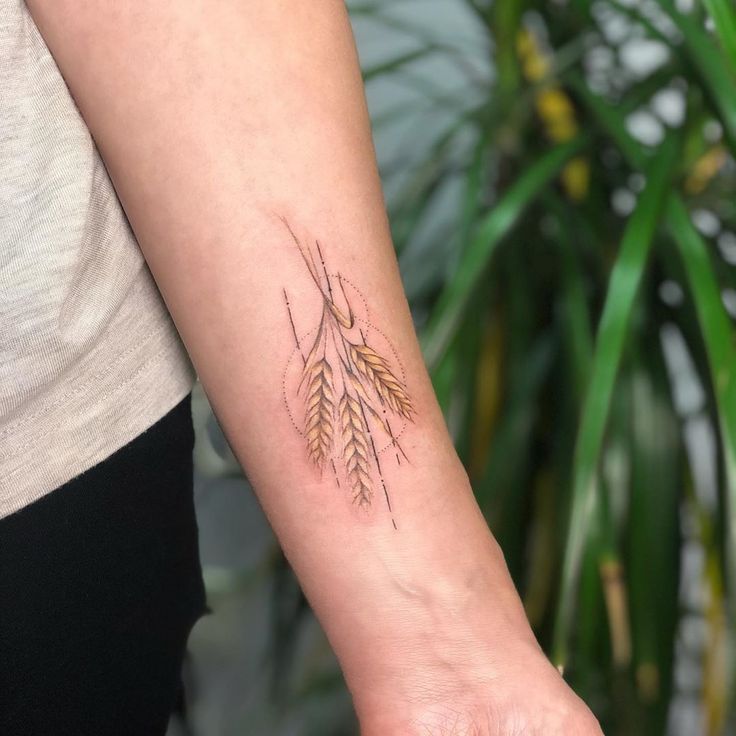 a woman's arm with a tattoo on it that has two arrows in the middle