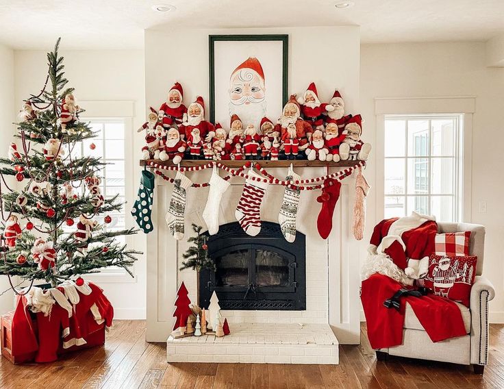 a living room decorated for christmas with stockings on the mantel and santa clause decorations