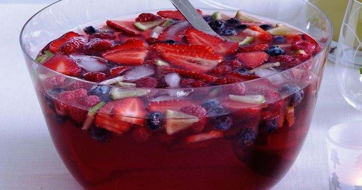 a glass bowl filled with fruit and ice