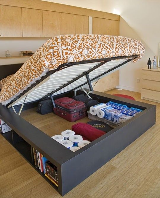 a bed with an open storage compartment underneath it