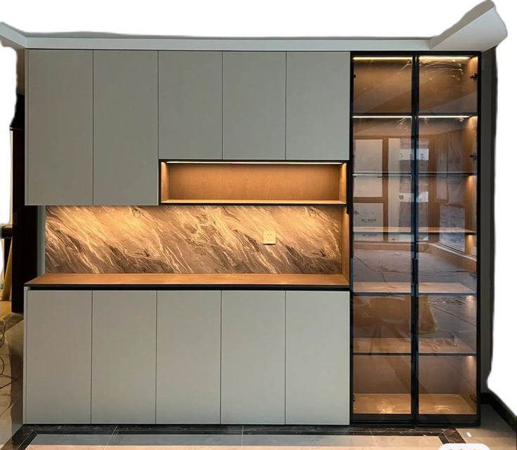 an empty kitchen with white cabinets and marble counter tops