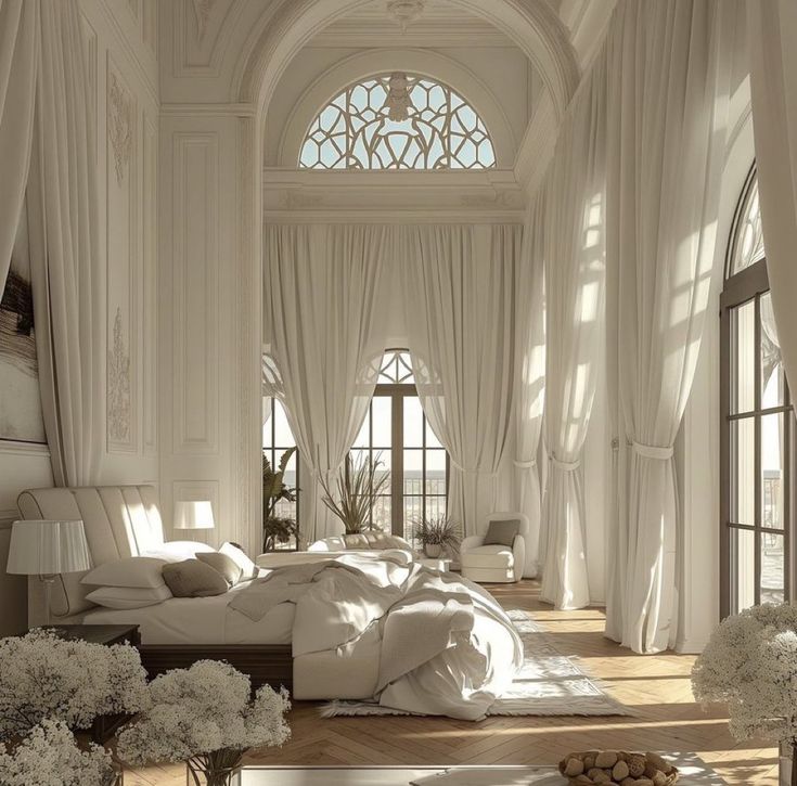 an elegant bedroom with large windows and white drapes