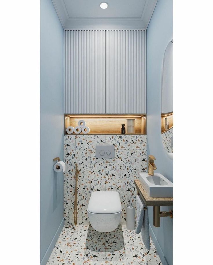 a small bathroom with blue walls and flooring is pictured in this image, there is a toilet that has its seat up