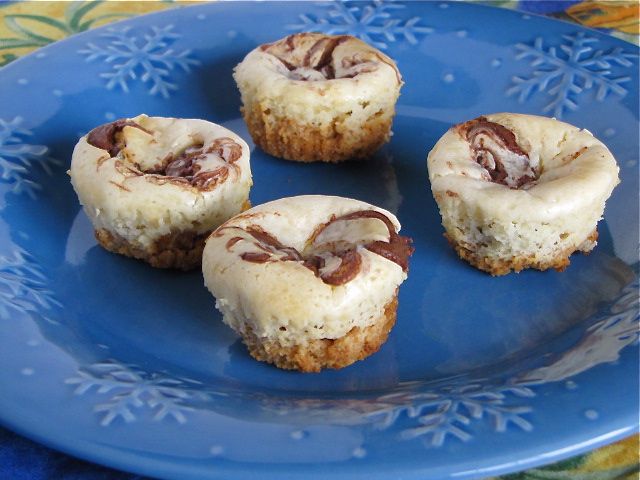 four mini desserts on a blue plate with snowflakes