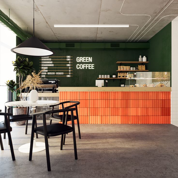 the interior of a coffee shop with green walls and orange accents on the counter top