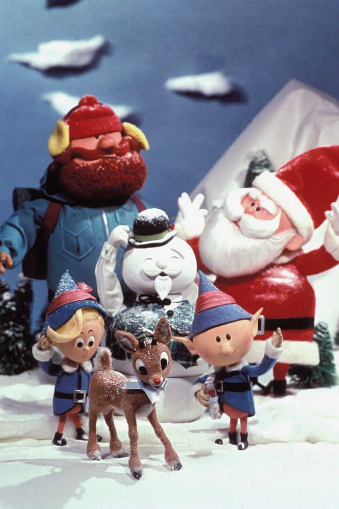 christmas figurines are posed in front of santa claus's sleigh