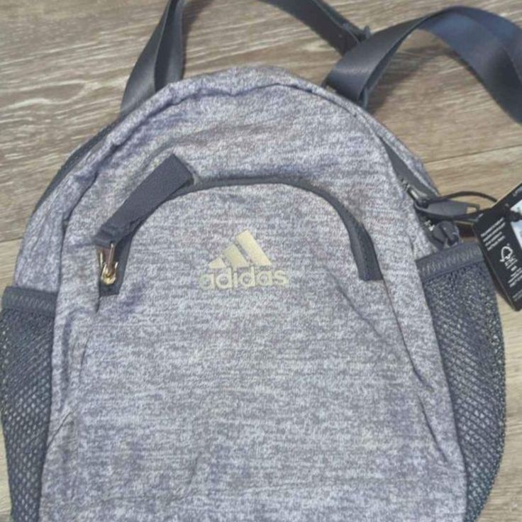 Adidas Linear Mini Backpack Gray New Sporty Adidas Backpack With Zipper Closure, Sporty Gray School Bag, Sporty Adidas Bag With Zipper Closure, Adidas Bags With Zipper Closure, Functional Adidas Bags For On-the-go, Adidas Bags With Zipper Closure For Everyday Use, Sporty Gray Bag For Back To School, Adidas Functional Everyday Bags, Adidas Sporty Backpack For Daily Use