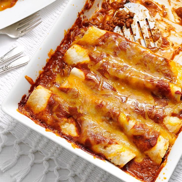 a white plate topped with lasagna and cheese