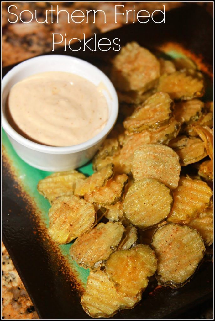 fried pickles on a plate with dipping sauce