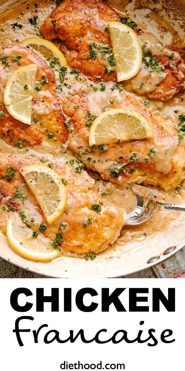 chicken with lemons and parsley in a skillet on top of a table