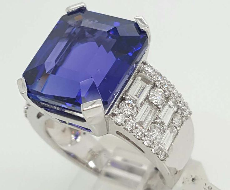 For Sale on 1stDibs - This modern vintage design includes a one of a kind rich emerald cut Tanzanite. The tanzanite has a deeply desired rich color violet, the purplish and Luxury Tanzanite Diamond Ring, Tanzanite Cocktail Ring, Luxury Blue Tanzanite Ring, Emerald-cut Tanzanite Jewelry With Vvs Clarity, Exquisite Blue Tanzanite Ring, Color Violet, Tanzanite Diamond, Diamond Cocktail Ring, Diamond Cocktail Rings