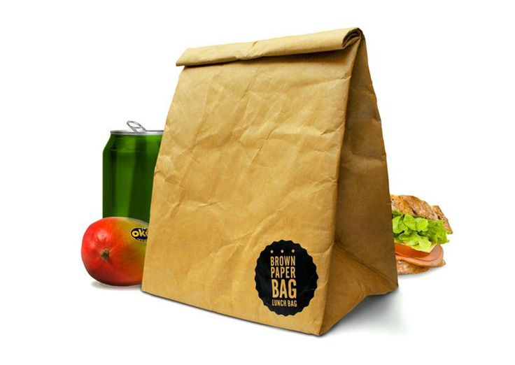 a brown paper bag sitting next to a can of soda and an apple on a white background