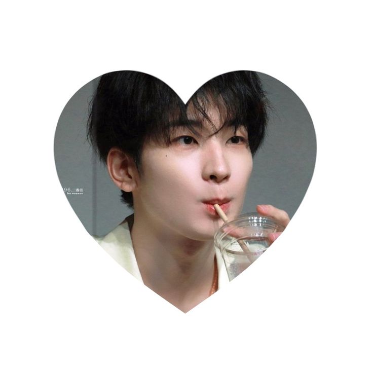 a man drinking from a glass in front of a heart shaped photo