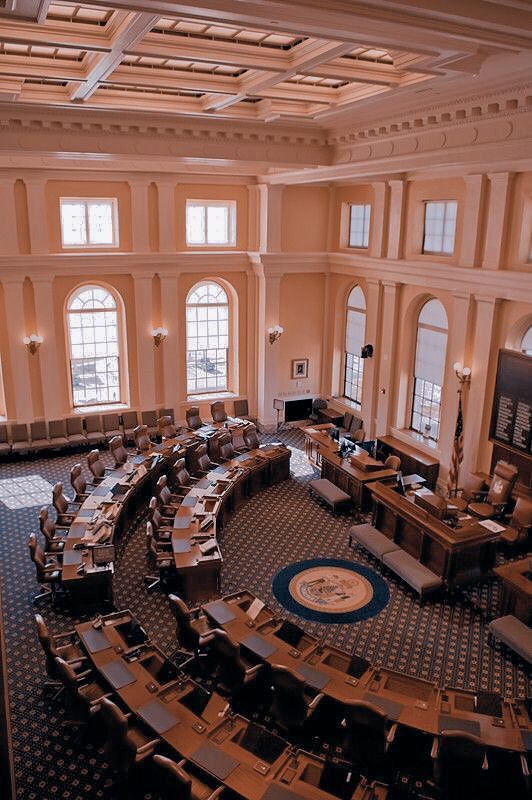 an aerial view of a large room with many chairs and desks in it,