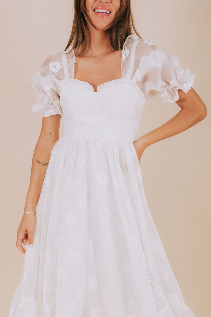 Indulge in a playful afternoon with our EXCLUSIVE Afternoon With You Dress. This white dress features delicate floral accents, puff sleeves, and a corset bodice for a flirty touch. Elastic along the shoulders and cuffs, corset tie back, and invisible zipper closure ensure a comfortable and perfect fit. Complete with ruffle details and a tier hem for a whimsical look. Say yes to this must-have dress! Details *Measurements are taken with item hanging and fabric unstretched.* White dress with white Corset Tie Back, Nursing Friendly Tops, Free People Sandals, Nursing Friendly Dress, Plus Swim, Plus Jumpsuit, Wedge Loafers, Corset Bodice, Exclusive Dress