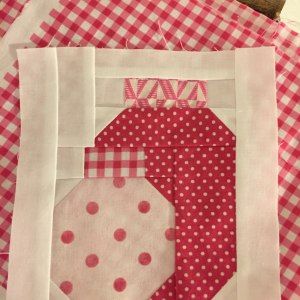 a close up of a piece of fabric on top of a table with a red and white checkered cloth