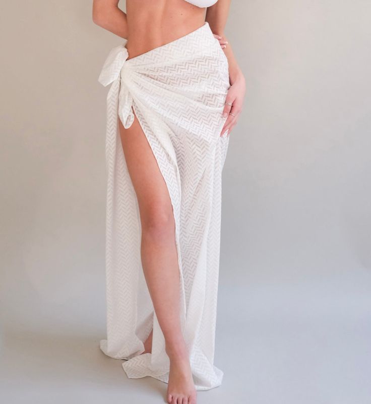 Whether you're planning a staycation or vacation, this Sarong is the perfect addition to your trip. tie it short or long wear it with a bikini and your good to go Measuring 50 inches long x 54 inches wide White Side Ties Swimwear For Pool, White Side-tie Swimwear For Pool, White Swimwear With Side Ties For Pool, Beachwear Swimwear With Side Ties For Beach Season, White Swimwear With Side Ties For The Beach, Summer Swimwear With Side Ties For Vacation, White Wrap Swimwear For Summer, Beachwear Swimwear With Side Ties, Beachwear Swimwear With Tie Waist For Vacation