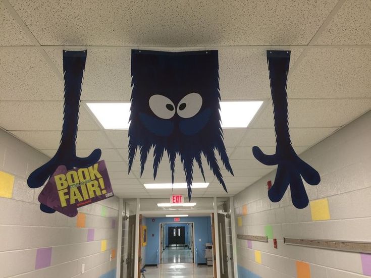 the hallway is decorated with paper cutouts and monsters hanging from it's ceiling