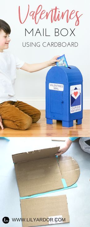 a boy sitting on the floor next to a mail box and some cardboard boxes that have been cut out