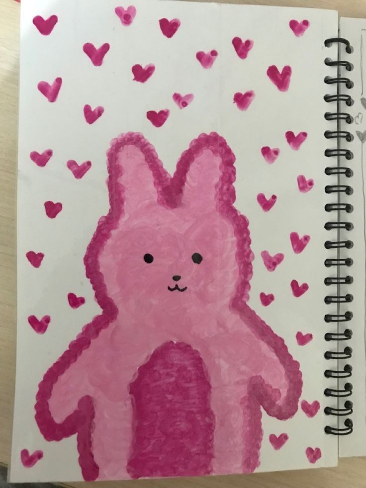 a drawing of a pink bunny with hearts on it's back and the shape of a heart in the background