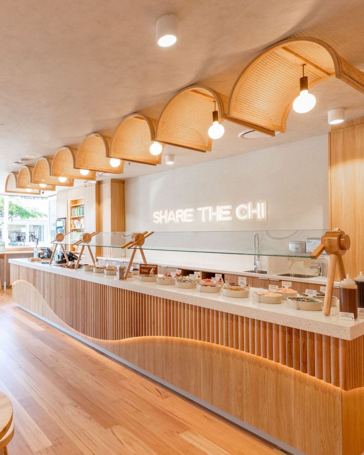 the inside of a restaurant with wooden tables and stools in front of it that says share the chii