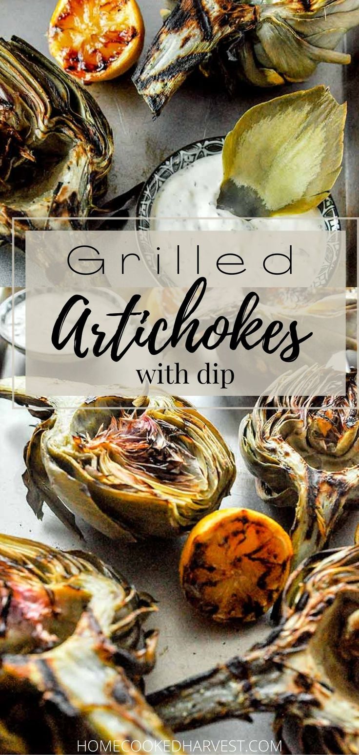 grilled artichokes with dip in the middle and an orange on the side