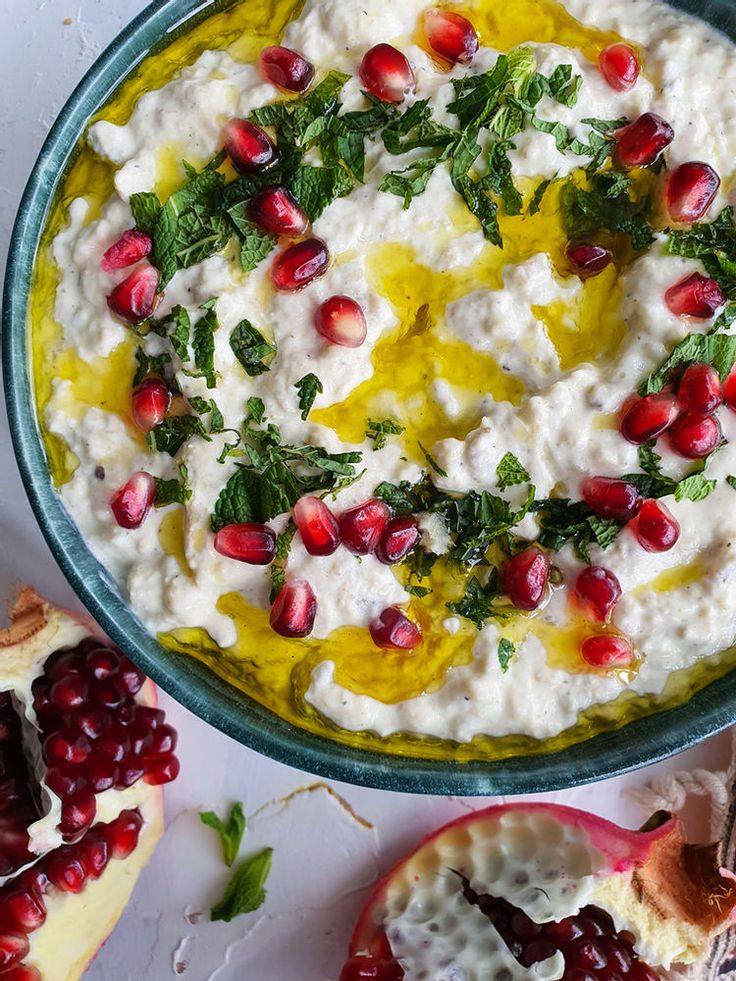 a bowl filled with mashed potatoes and pomegranates