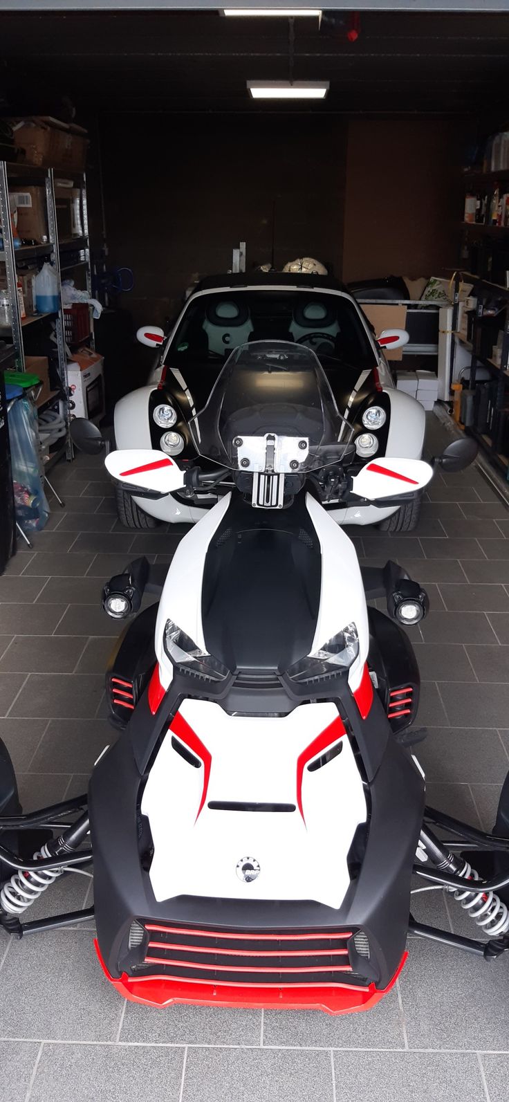 two white and red sports cars parked in a garage