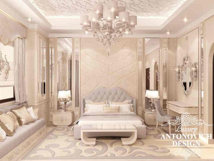 an elegant bedroom with white furniture and chandelier