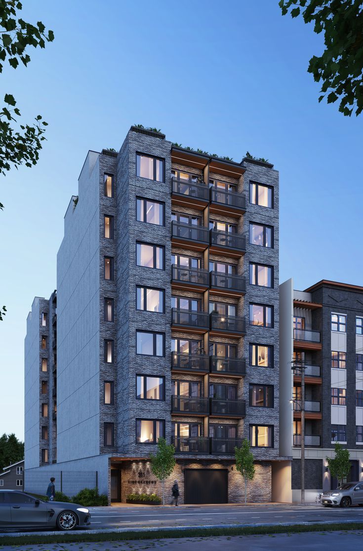 an apartment building with multiple balconies on the top floor and windows above it