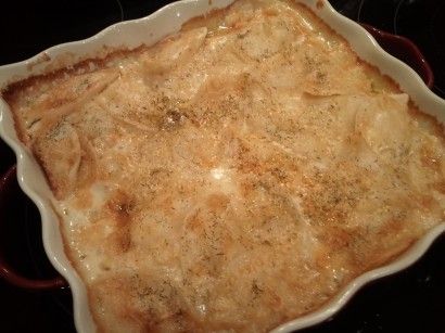 an uncooked casserole sitting on top of a stove in a pan