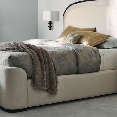 With a subtle nod to the grandeur of Art Deco, this upholstered bed introduces a harmonious mix of neutral hues, textures, and materials. It features an arched headboard accentuated with Sun-kissed Silver raffia, trimmed in Deep Bronze and wood banding in a Seal Skin finish. Elevated on a wood plinth base, its side rails and gently curving footboard are fully upholstered in an inviting, ivory textured woven. Rattan Bed, Arched Headboard, Cal King Bedding, Modern Mountain Home, Beige Bed, A Seal, Bed Bench, Modern Mountain, Linen Upholstery