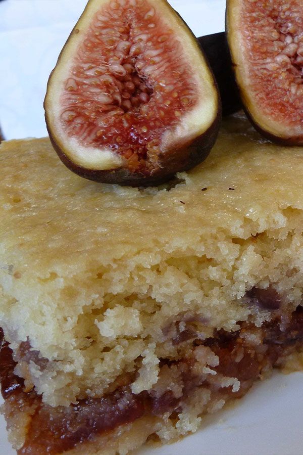 a piece of cake with two figs on top