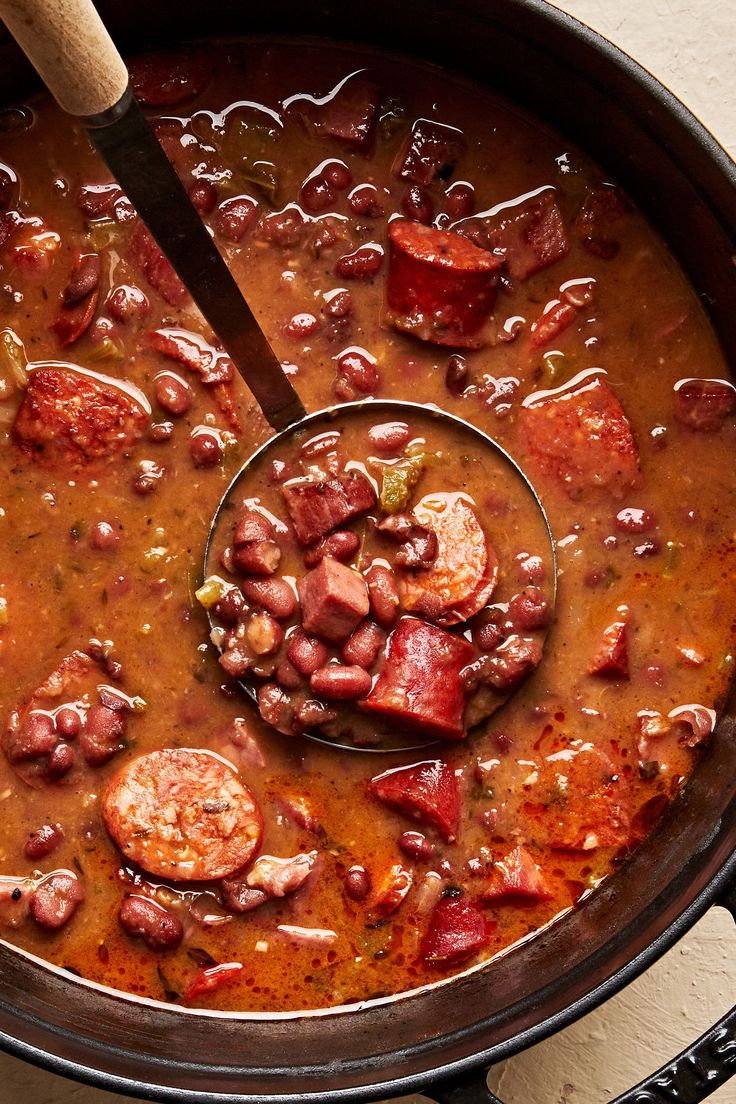 a large pot filled with beans and sausage