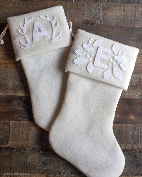 two white christmas stockings with monogrammed letters on them