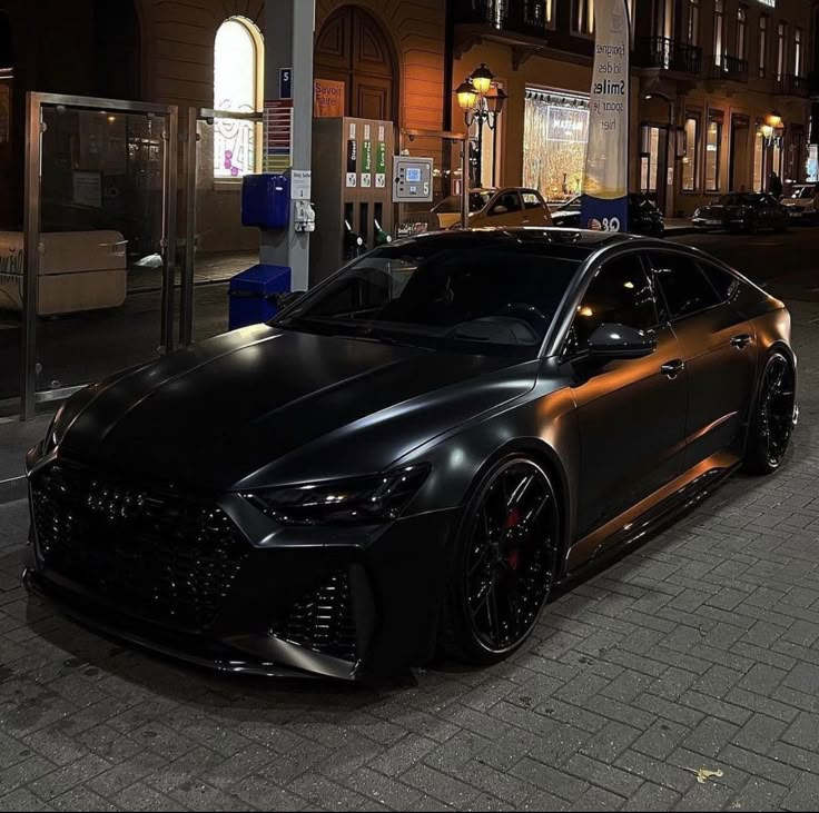 a black sports car parked on the street at night