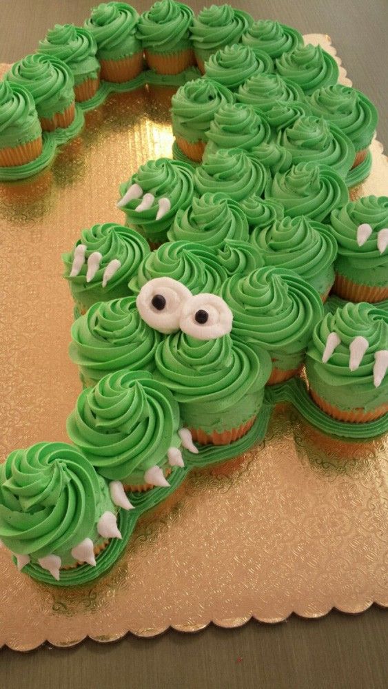 cupcakes with green frosting shaped like a crocodile