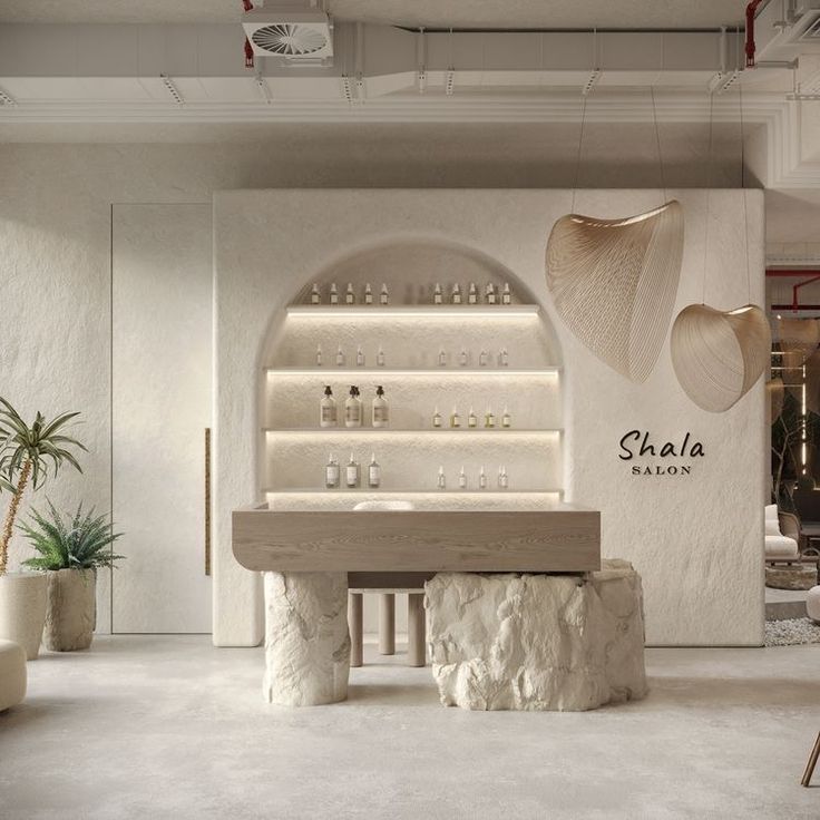 the interior of a salon with white walls and stone stools in front of it