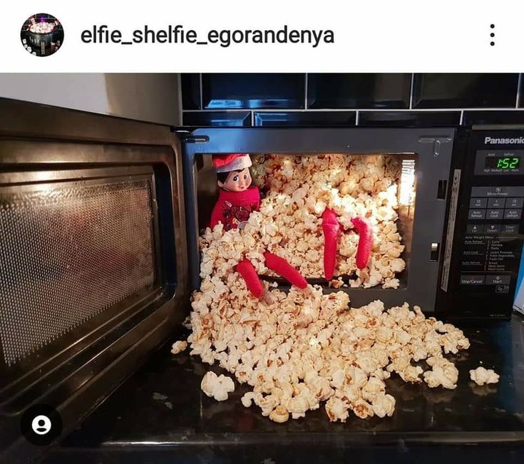 an elf is in the microwave with popcorn