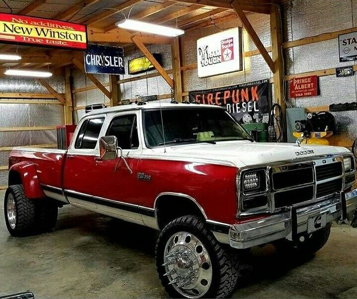 a red and white truck parked in a garage