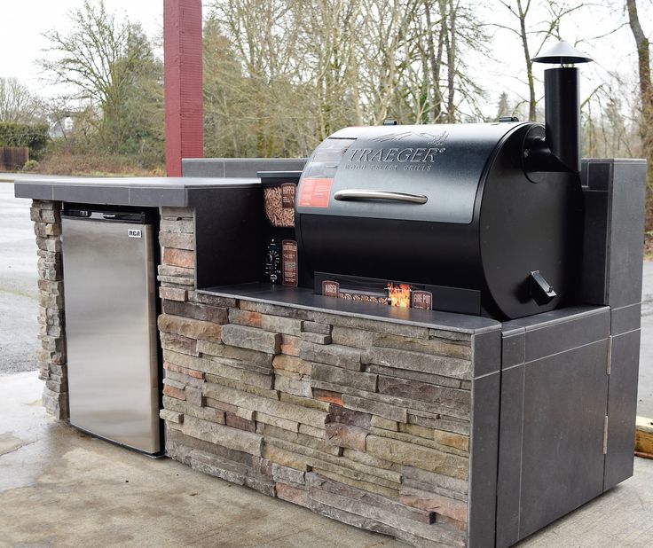 an outdoor bbq grill made out of stone