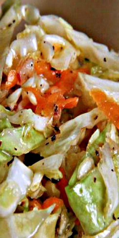 a salad with carrots and lettuce in a bowl