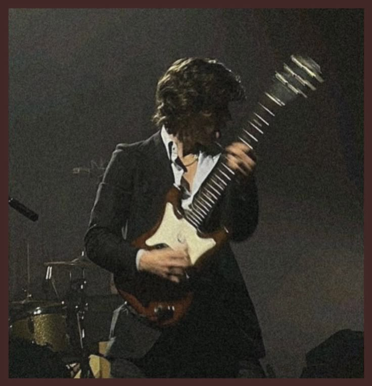 a man playing an electric guitar on stage