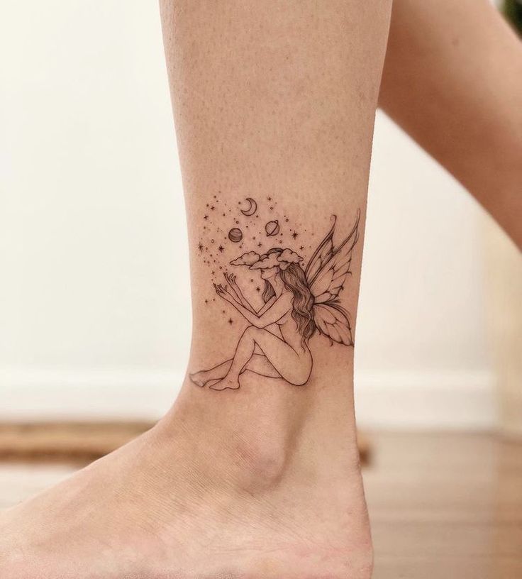 a small tattoo on the ankle of a woman's leg with a fairy sitting on it