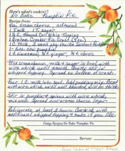 a handwritten recipe card with oranges and leaves on the border, in blue ink